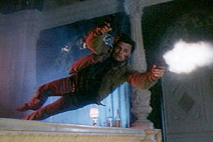 Nick flies over the bar, guns blazing, to save Shu's girlfriend.