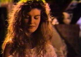 Elena (Rene Russo) looking down shyly as Grishka compliments her