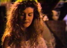 Elena (Rene Russo) looking down shyly as Grishka compliments her